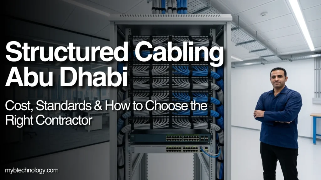 structured cabling Abu Dhabi certified engineer standing next to organised Cat6A network rack in commercial office building